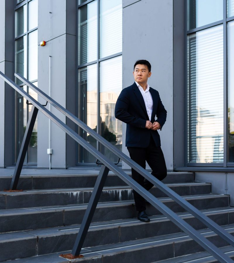 asian-businessman-walks-up-the-stairs-of-the-offic-2022-08-08-19-09-59-utc asian-businessman-walks-up-the-stairs-of-the-offic-2022-08-08-19-09-59-utc